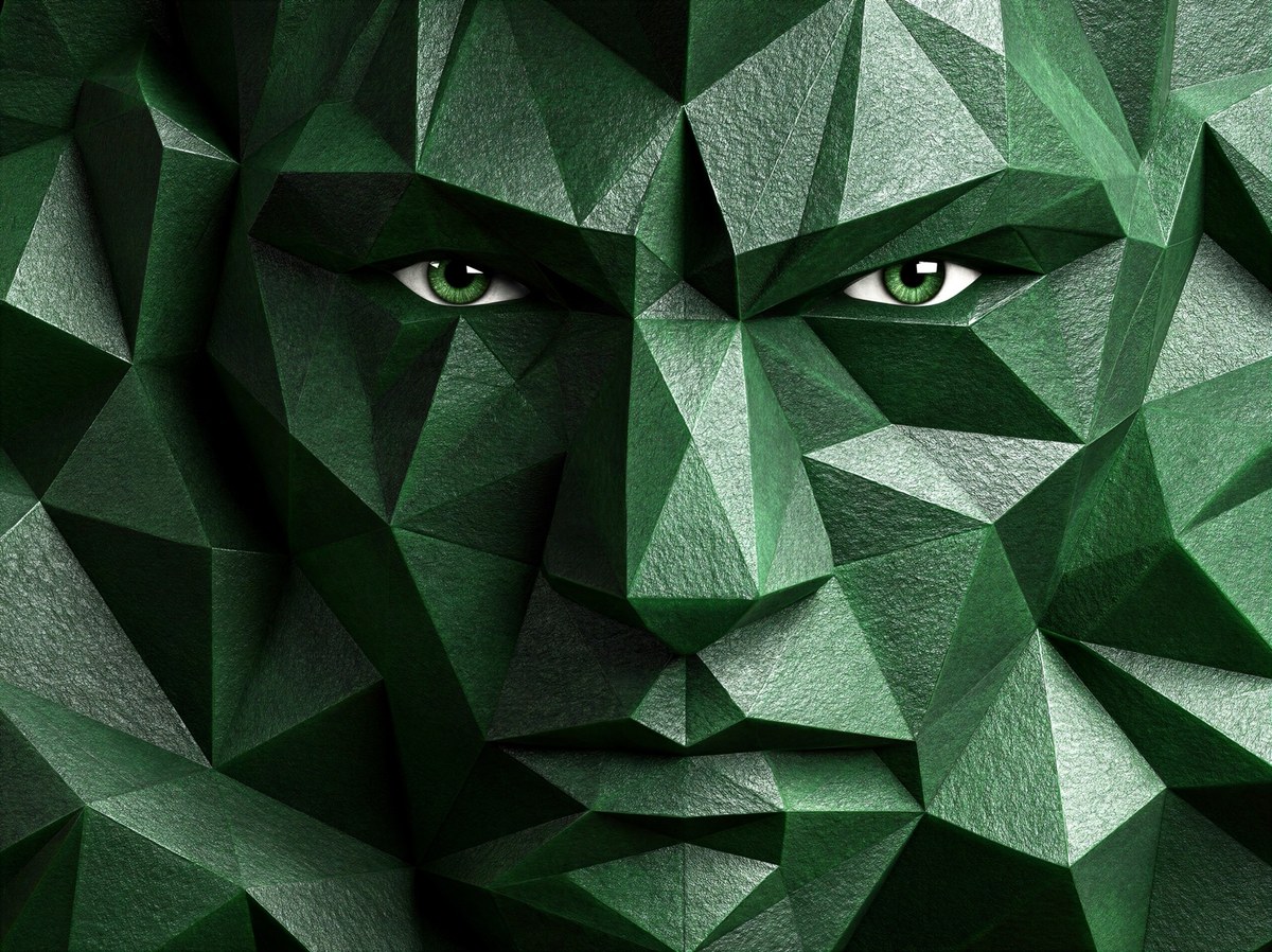 Emerald green geometric face formed from angular facets with detailed green eyes